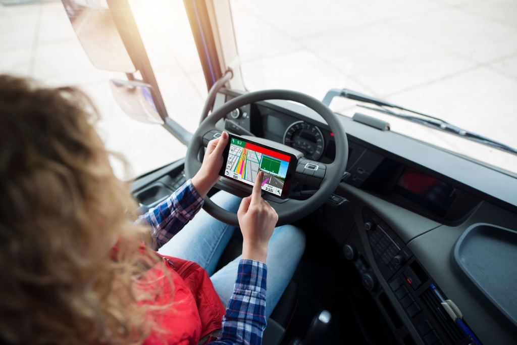 Shot of an unrecognizable truck driver using global positioning system GPS navigation for destination. Fingers choosing route navigation. Transportation services.