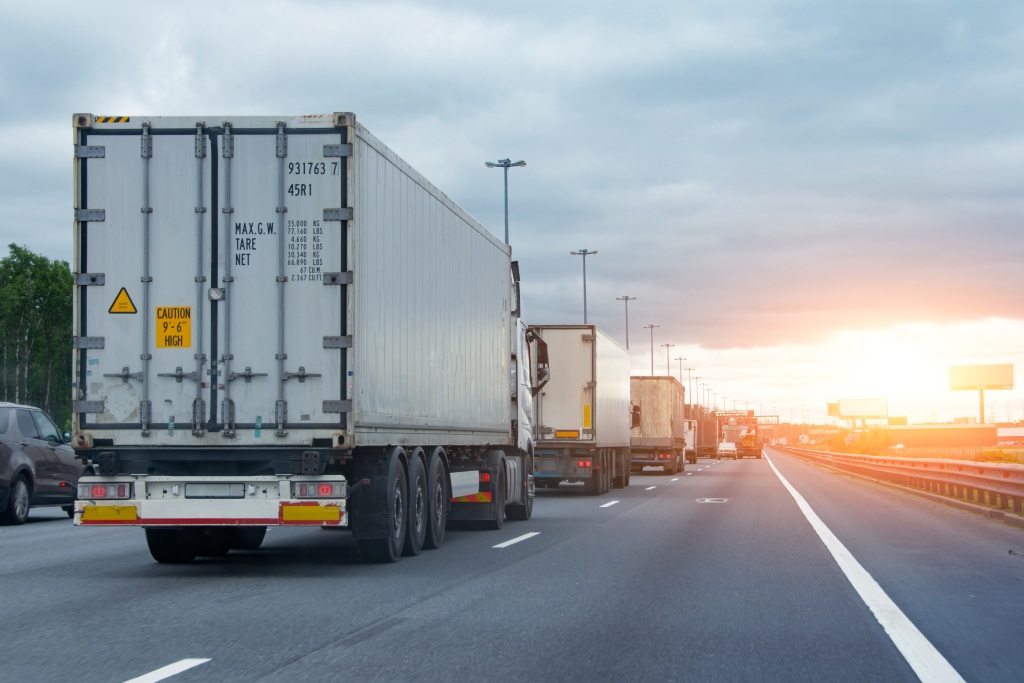 Lorry trucks cars in traffic jam at border zone custom, sunset time